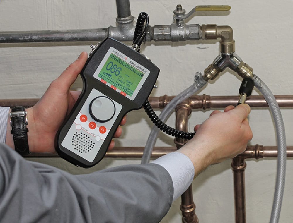 Plumber testing pipes with electronic leak detection equipment in Leesburg