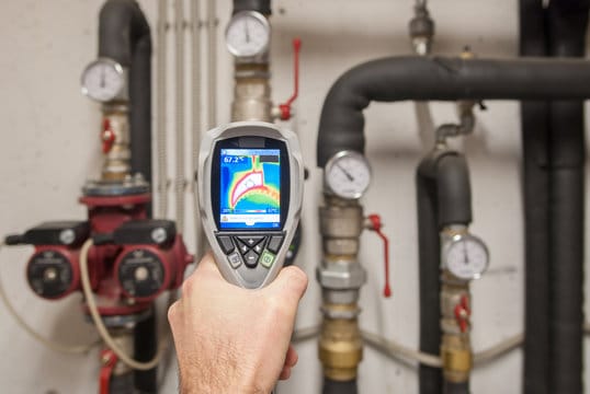 Plumber using a thermal imaging camera to inspect pipes in Leesburg
