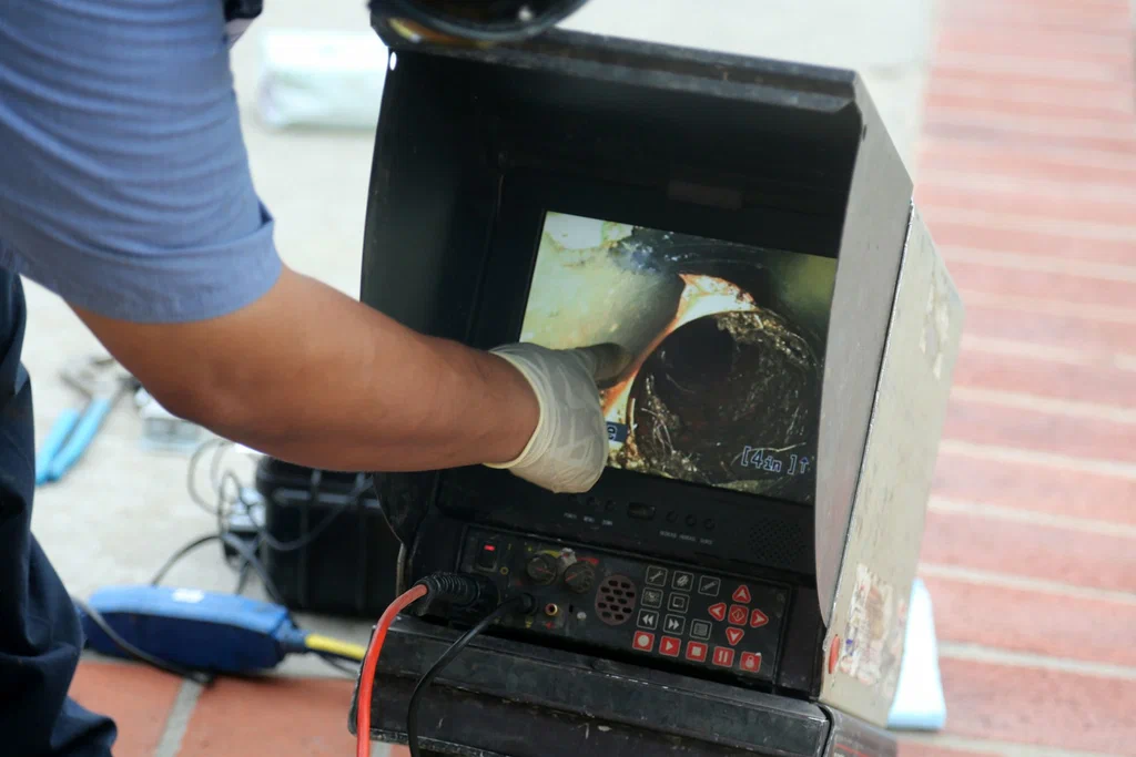 Technician viewing a drain inspection camera in Leesburg