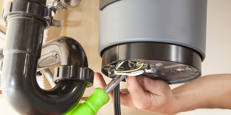 Technician repairing the heating element of a water heater in Leesburg