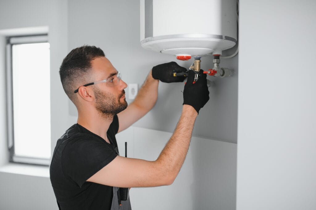 Technician performing water heater maintenance in Leesburg